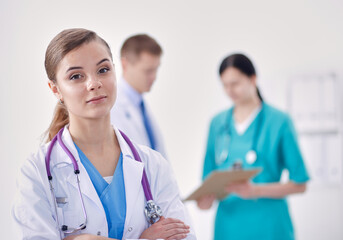Attractive female doctor in front of medical group.
