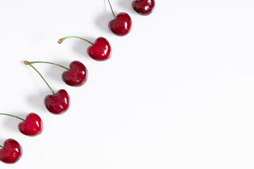 Obraz na płótnie Canvas Red cherry on white background. Ripe red cherry berries as background. Flat lay, top view, copy space