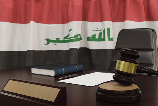 Law and justice concept,  gavel on a wooden desktop and the Iraq flag on background. 3d render.