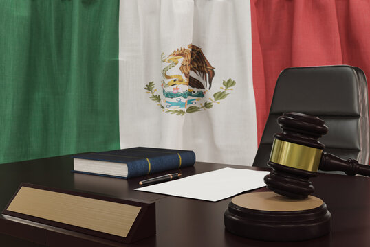 Law and justice concept,  gavel on a wooden desktop and the Mexico flag on background. 3d render.