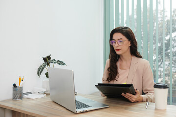 Portrait of serious HR manager checking cv of candidates before interview