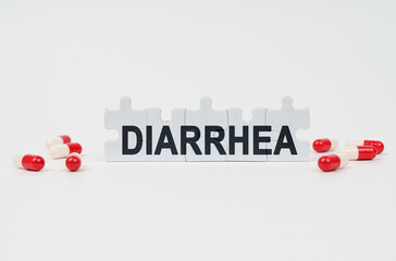 On a white surface are tablets and puzzles with the inscription - DIARRHEA