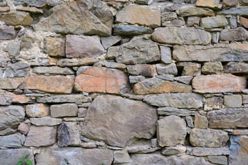 Historic dry stone wall made of grey sandstone
