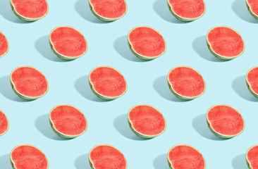 Pattern of cut watermelon on blue pastel background