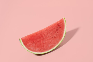 Cut watermelon on red pastel background