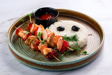 chicken kebab on a stick with rice and ketchup