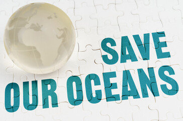 On white puzzles there is a glass globe and the inscription - SAVE OUR OCEANS