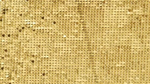 rows of blinking golden yellow brass metal plaques sway in wind and shines in sun and create unique pattern of movement. round reflective particles texture glitter under waves of wind. Spangle Glitter