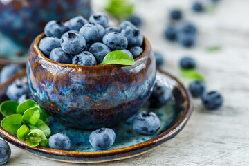 Fresh blueberries background with copy space for your text.Blueberries in a bowl on a wooden table. Blueberry antioxidant organic superfood in a bowl concept for healthy eating and nutrition