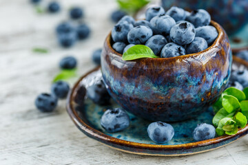Fresh blueberries background with copy space for your text.Blueberries in a bowl on a wooden table. Blueberry antioxidant organic superfood in a bowl concept for healthy eating and nutrition