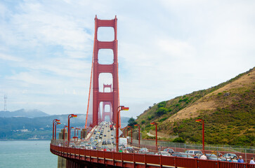 SAN FRANCISCO, CA,USA - 2015, JULY 1: Golden Gate bridge with cars, trucks, buses, pedestrians and...