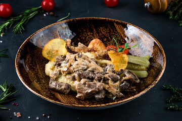 Beef stroganoff. The traditional dish of Russian cuisine. Beef meat in a thick sauce on sour cream