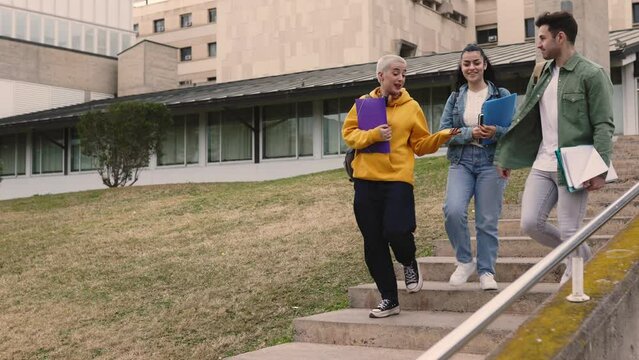 Young group of university student friends walking on college campus. Slow motion high quality 4k footage