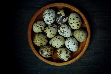 Fresh quail eggs close up on a wooden table small hard boiled eggs rustic top view
