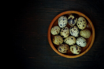 Fresh quail eggs close up on a wooden table small hard boiled eggs rustic top view