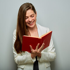 Teacher or female student reading red book isolated portrait. White business suit.