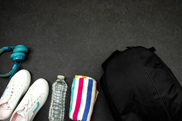 Healthy lifestyle, sport or athlete's equipment set : black backpack and bottle of water with blue...