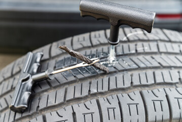 Tubeless tire repair, close-up. Tire plug repair kit for tubeless tires for cars and motobikes