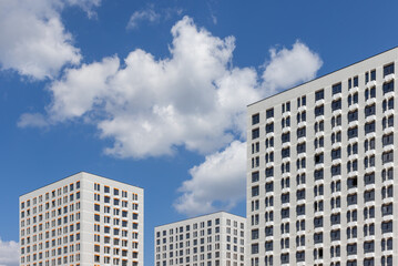 Fototapeta na wymiar New modern residential apartment buildings newly build on blue cloudy sky 