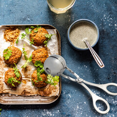 cooking tool for meatballs on kitchen salt next to ready-made meatballs