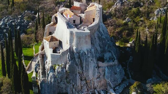 Aerial drone shot of the Sokol Fortress or Sokol Grad. One of the most important defensive medieval castles of the Dubrovnik Republic. Mountainous region near the Bosnian inland, Croatia. 4K UHD