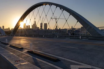 Fototapeten Lens flare at sunset on the 6th street bridge in Los Angeles with the skyline in the distance © James