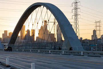 Lens flare at sunset on the 6th street bridge in Los Angeles with the skyline in the distance
