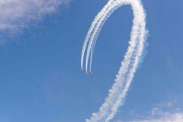 three red planes make a loop in the blue sky