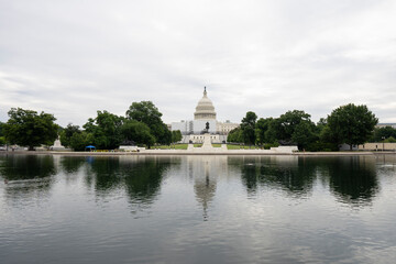 The West Front of the United States Capitol viewed from the Capitol Reflecting Pool in the morning.