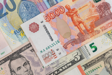Money from different countries: dollars, euros, rubles. International currencies background.