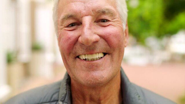 Laughing man showing white teeth or dentures after dental treatment in the city. Closeup headshot and face portrait of a happy, smiling mature man. Content, confident and proud during a day in town