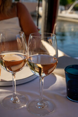 Dinner at sunset in French restaurant with cold dry rose wine in Port Grimaud, summer vacation on French Riviera, France