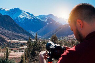 back view of photographer taking panoramic photos of the valley, Valle del Elqui