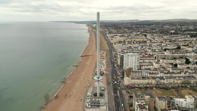 Aerial flyover and tilt down British Airways i360 tower Brighton Beach UK