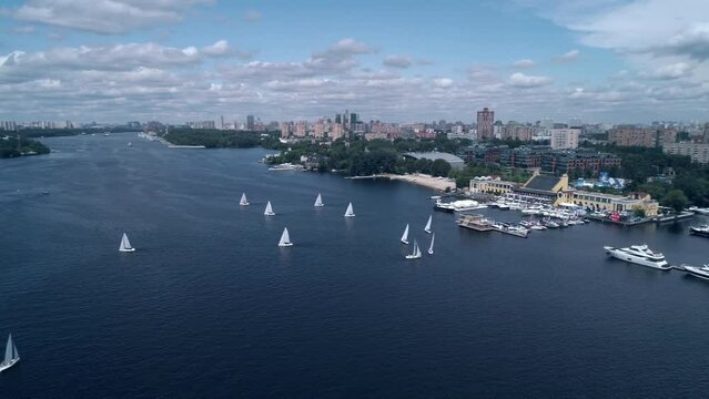 Breathtaking aerial view of yachts race across the river. yacht competition on the background of the city.