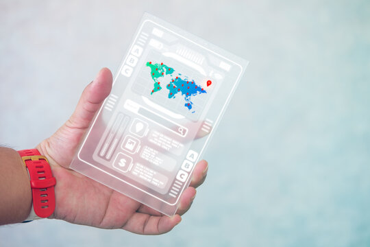 Man holding transparent tablet with futuristic hud screen for search point around the world. HUD ui futuristic user interface - Powered by Adobe