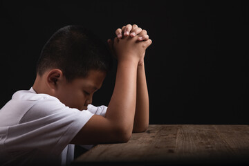 Boy praying to God at home