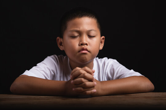 Boy praying to God at home