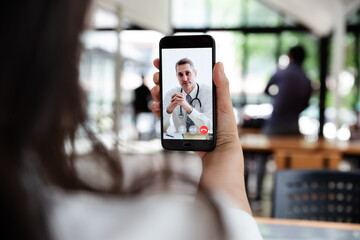 Businesswoman talking with doctor online from office.
