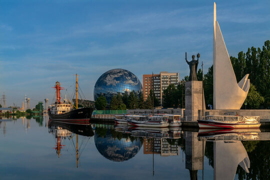 View of the World Ocean Museum on the embankment of the Pregolya River and a single ensemble of monuments to Fishermen and Nicholas the Wonderworker on a sunny summer day, Kaliningrad, Russia