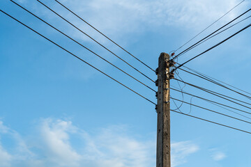 Power poles and power lines and blue sky background. Concept of energy technology, power supply and...