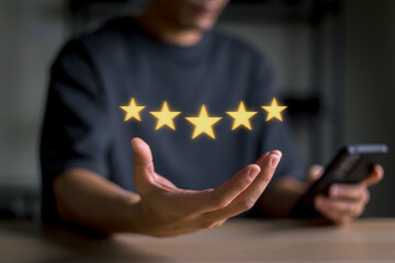 Business hands are showing a symbol of excellent service, 5-star quality, coupled with the use of Smartphone, warranty, satisfaction, support of excellent. and standardization concept.
