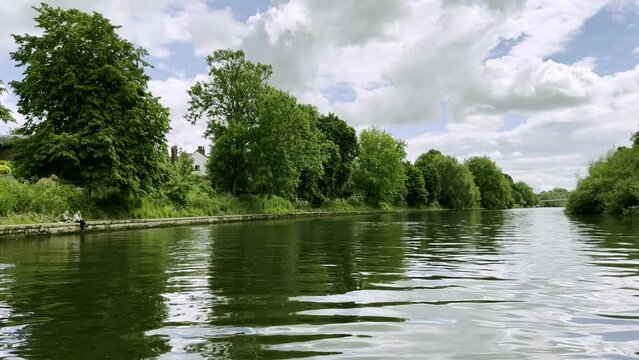 The view of boating in the middle of the green river on a lovely day