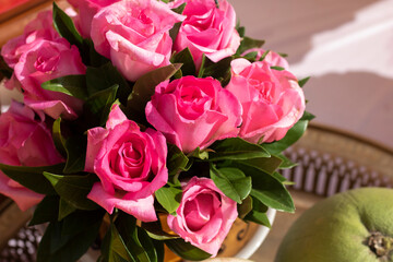 Many pink roses are arranged in bouquets.