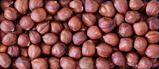 Pile of hazelnut kernels, close-up, top view, macro.