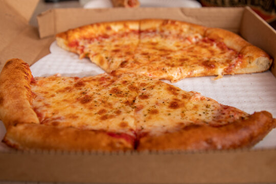 A delicious cheese pizza is ready to enjoy. 
