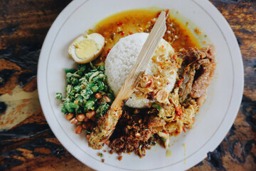 Nasi Campur Ayam Betutu. Balinese roast chicken stuffed with cassava leaves. Accompanied with...