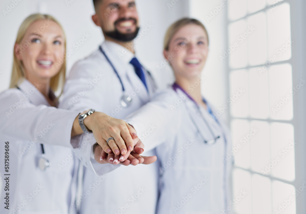 Wall mural doctors and nurses coordinate hands. concept teamwork in hospital for success work and trust in team