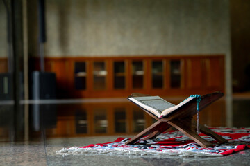 Islamic concept - The Holy Al Quran with written Arabic calligraphy meaning of Al Quran and rosary...