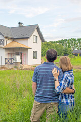 Young Couple Standing Outside Dream Home